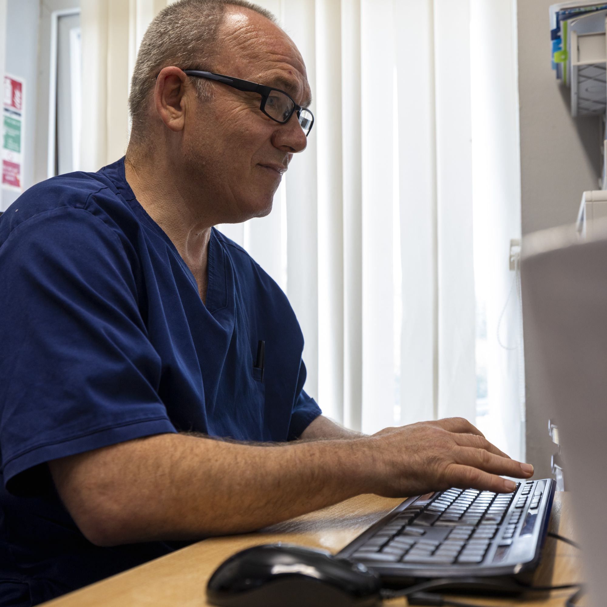 A man typing on a computer keyboard