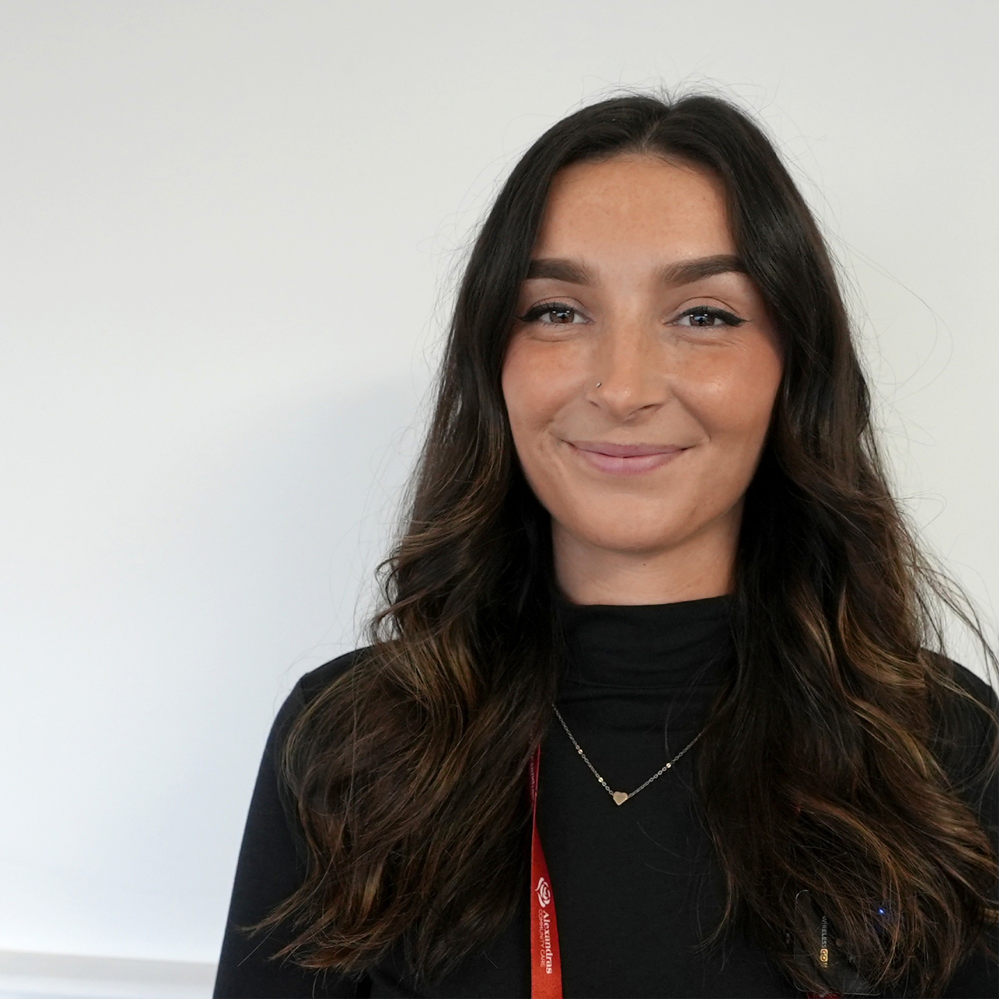 A young female home care manager smiling at the camera